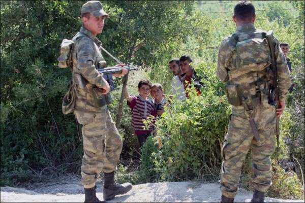 Two Versions of the Same Syria – Turkey Border Photo. Does It Make a Difference?