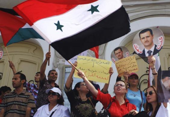 Assad hand sign Tunis