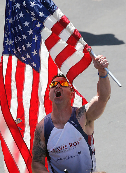 Runner holds flag Marathon Getty