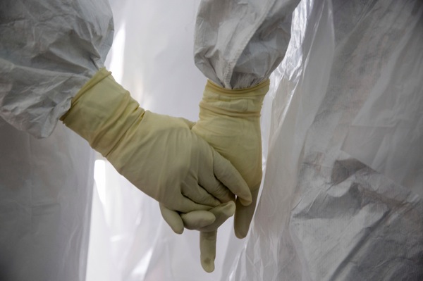 Glenna Gordon Ebola gloves holding hands