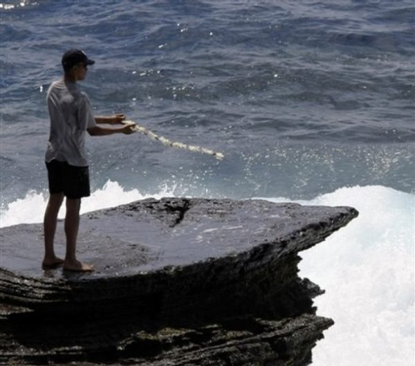 Democratic presidential candidate Sen. Barack Obama, D-Ill., throws a lei at the point where he scattered his mother's ashes in Honolulu, Hawaii, Thursday, Aug. 14, 2008. Sen. Obama is in Hawaii for a vacation with his family. (AP Photo/Alex Brandon)