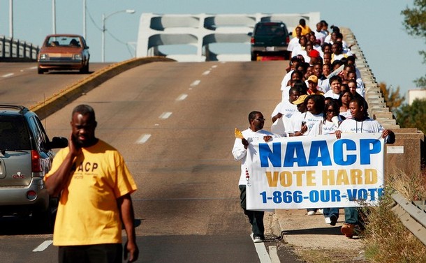 SELMA, AL - NOVEMBER 01:  College students on the NAACP's "Vote Hard" bus tour walk across the historic Edmund Pettis Bridge November 1, 2008 in Selma, Alabama. The bridge was where civil rights marchers on the first Selma to Montgomery march were forcibly turned back by police using clubs and tear gas in 1965. The marches eventually led to the Voting Rights Act of 1965 ending voter disfranchisement against African-Americans. Americans are gearing up for the first presidential election featuring an African-American to be officially nominated as a candidate for U.S. president by a major party, Democratic contender Sen. Barack Obama (D-IL), who is running against Republican Sen. John McCain (R-AZ).  (Photo by Mario Tama/Getty Images)