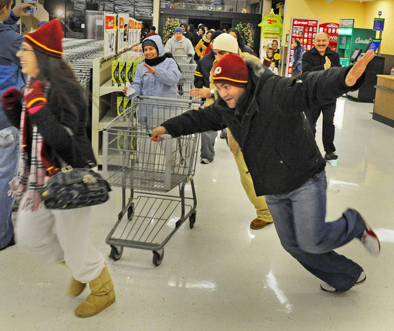 Gerald Martineau-The Washington Post. caption: Shoppers burst through the doors at the Wal-Mart in Fair Lakes Center when the store opened at 5 a.m. Friday morning