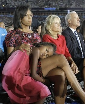 Michelle Obama, has Sasha Obama, 7, on her lap as they listen to Democratic presidential candidate, Sen. Barack Obama, D-Ill., give his acceptance speech with Jill Biden and Sen. Joe Biden, D-Del., right, at the Democratic National Convention at Invesco Field at Mile High in Denver Thursday, Aug. 28, 2008.(AP Photo/Alex Brandon)