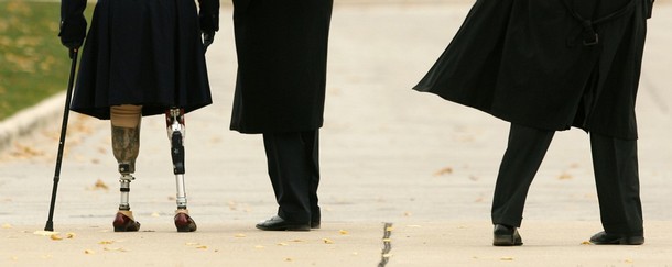 U.S. President-elect Barack Obama (C), paraplegic Iraq war veteran Tammy Duckworth and a Secret Service agent (R) walk away after placing a wreath at a veterans memorial in Chicago November 11, 2008. Duckworth is director of the department of veteran affairs for Illinois. REUTERS/Kevin Lamarque          (UNITED STATES)