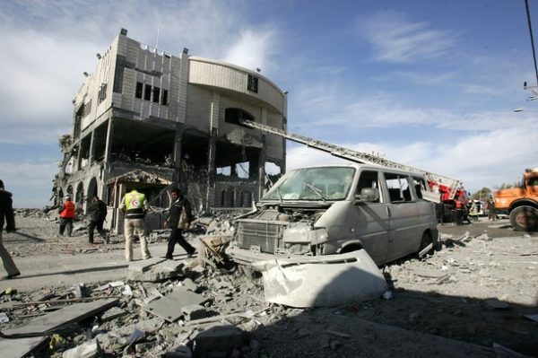 GAZA CITY, GAZA STRIP - DECEMBER 27: Palestinians inspect the presidential building; the office of president Mahmoud Abbas (which is now under Hamas control), after it was destroyed by an Israeli air strike on December 27, 2008 in Gaza City, Gaza. Israel's air force fired about 30 missiles at targets along the Gaza Strip on Saturday, destroying several Hamas police compounds, killing more than 155 people and wounding hundreds. (Photo by Abid Katib/Getty Images)