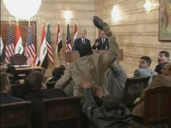 In this image from APTN video, a man, centre throws a shoe at US President George W. Bush, background left, during a news conference with Iraq Prime Minister Nouri al-Maliki, Sunday, Dec. 14, 2008, in Baghdad, Iraq. On an Iraq trip shrouded in secrecy and marred by dissent, President George W. Bush on Sunday hailed progress in the war that defines his presidency and got a size-10 reminder of his unpopularity when a man hurled two shoes at him during a news conference. (AP Photo)