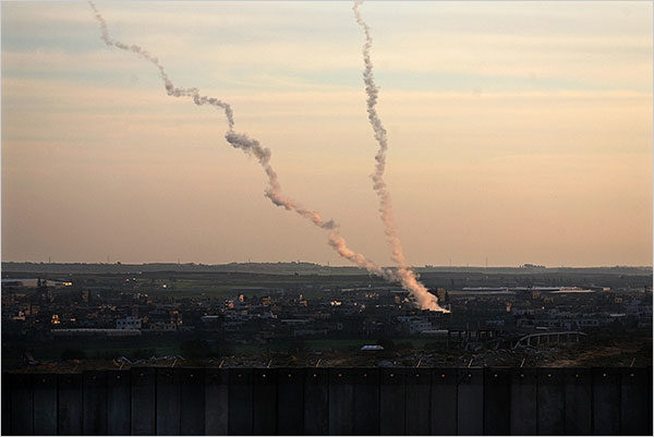 Rina Castelnuovo for The New York Times. caption: Two rockets fired from inside Gaza as seen from the Israeli side of the border
