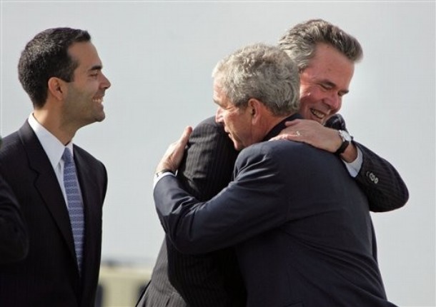 President George W. Bush receives a hug from his brother former Gov. Jeb Bush as George P. Bush looks on during the President's arrival in Palm Beach County for a fundraiser.   (AP Photo/Allen Eyestone,Pool)