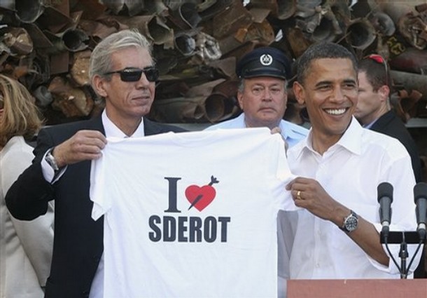 U.S. Democratic presidential contender Sen. Barack Obama, D-Ill., right,  is presented with an "I Love Sderot" T-shirt with a rocket in a heart by Sderot Mayor Eli Moyal as they stand in front of a display of rockets that landed in southern Israel, during a visit to Sderot, southern Israel, Wednesday, July 23, 2008. Obama pledged Wednesday that as president he would preserve the close ties between the United States and Israel, and that the Jewish state's security would be a top priority in his administration.(AP Photo/Rina Castelnuovo, Pool)