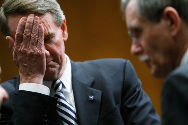 WASHINGTON - DECEMBER 04: Richard Wagoner Jr., chairman and CEO of General Motors (L) wipes his eyes as he awaits the start of a Senate hearing on the auto industry December 4, 2008 in Washington, DC. Leaders from the three major U.S. automakers are scheduled to appear before members of the Senate today to discuss proposed bailout legislationm for their industry. (Photo by Chip Somodevilla/Getty Images)