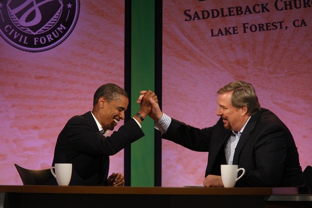 LAKE FOREST, CA - AUGUST 16: Pastor Rick Warren (R) and presumptive Democratic Presidential candidate U.S. Sen. Barack Obama (D-IL) join hands during the Civil Forum on the Presidency at the Saddleback Church August 16, 2008 in Lake Forest, California. In the first joint appearance of candidates, Obama and Presumptive Republican Presidential candidate U.S. Sen. John McCain (R-AZ) participated in a town hall style meeting moderated by the Saddleback Church pastor Rick Warren, who leads the fourth-largest church in the nation. Each candidate was questioned, separately, about issues of poverty, HIV/AIDS, climate and human rights. Neither candidate was allowed to hear the responses of the other. (Photo by David McNew/Getty Images)