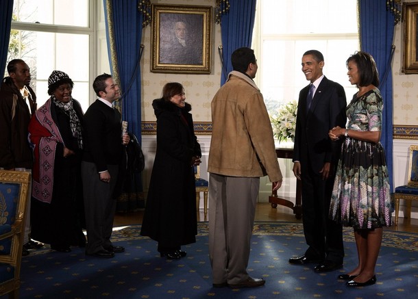 WASHINGTON - JANUARY 21: U.S. President Barack Obama (2nd R) and first lady Michelle Obama (R) greet people in the Blue Room of the White House during an open house reception January 21, 2009 in Washington, DC. Obama invited members of the public into the White House during the first full day of his administration. (Photo by Martin H. Simon-Pool/Getty Images)