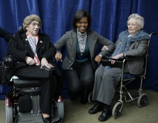 US first lady Michelle Obama poses with veterans Alyce Dixon, 102, and Ester P. Corcoran, 103, (R) at Arlington National Cemetery's Women in Military Service for America Memorial Center in Washington on March 3, 2009. AFP PHOTO/YURI GRIPAS (Photo credit should read YURI GRIPAS/AFP/Getty Images)