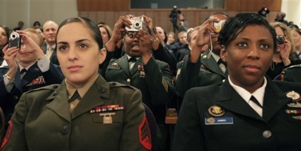 Members of the armed forces listen and photograph first lady Michelle Obama as she speaks at Arlington National Cemetery's Women in Military Service for America Memorial Center in Arlington, Va., Tuesday, March 3, 2009.(AP Photo/Alex Brandon)