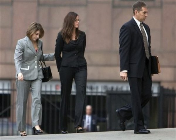 Laura Pendergest-Holt, the chief investment officer of troubled Stanford Financial Group, center, is brought into the Federal Court building, Friday, Feb. 27, 2009, in Houston. Pendergest-Holt faces charges she obstructed the Securities and Exchange Commission investigation of the Stanford scandal by lying about her knowledge of the firm's activities and by omitting key details. (AP Photo/Houston Chronicle, Sharon Steinmann)