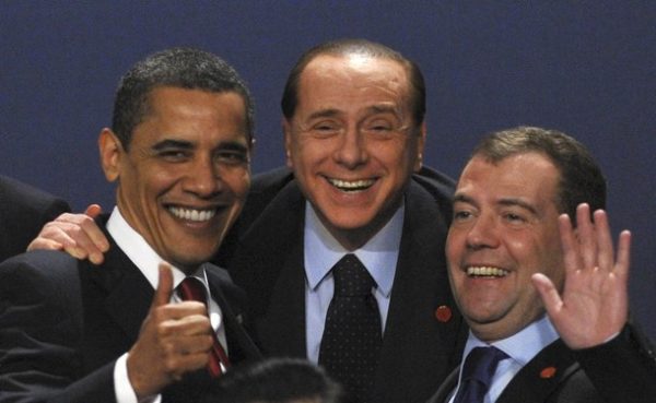 U.S President Barack Obama (L) laughs with Italy's Prime Minister Silvio Berlusconi (C) and Russia's President Dmitry Medvedev as they pose for a family photograph at the G20 summit at the ExCel centre, in east London April 2, 2009. World leaders are set to declare an end to unfettered capitalism at a G20 summit on Thursday after France and Germany demanded they act fast on promises to prevent a repeat of the worst economic crisis since the 1930s.  REUTERS/Stringer  (BRITAIN BUSINESS POLITICS)