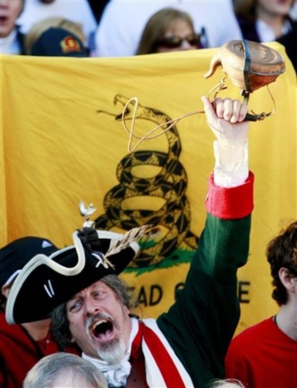 A man  holds up a tea kettle during the Atlanta Tea Party tax protest Wednesday, April 15, 2009 in Atlanta. Thousands of protesters, some dressed like Revolutionary War soldiers and most waving signs with anti-tax slogans, gathered around the nation Wednesday for a series of rallies modeled after the original Boston Tea Party. (AP Photo/John Bazemore)