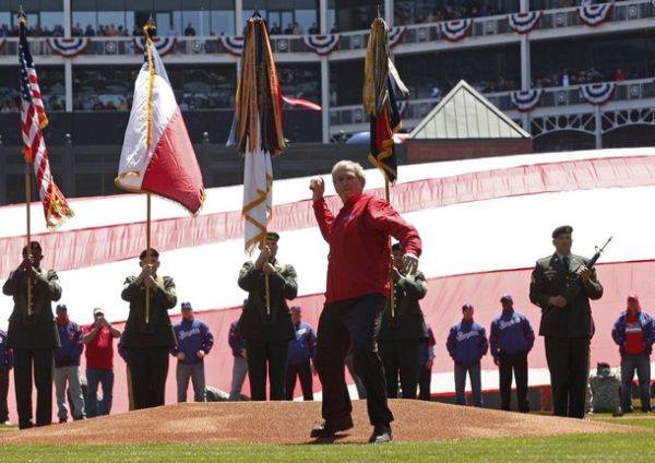Former U.S. President George W. Bush throws out the ceremonial first pitch before the start of American League MLB baseball action between the Texas Rangers and the Cleveland Indians in Arlington, Texas April 6, 2009. REUTERS/Jessica Rinaldi (UNITED STATES SPORT BASEBALL POLITICS)