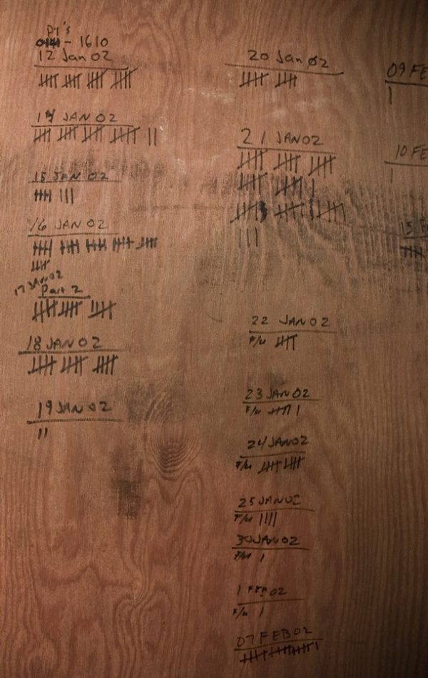 (FILES): This April 25, 2007 file photo shows an improvised record of detainees treated still seen on the plywood wall of the hospital facility at Camp X-Ray, long ago abandoned for more modern facilities, at the US Naval Station in Guantanamo, Cuba. US President Barack Obama on April 16, 2009 granted immunity to CIA officers involved in tough terror interrogations as he released graphic memos detailing harsh methods approved by ex-president George W. Bush. In the documents, Bush-era legal officials argued that such tactics that Obama has since disowned such as simulated drowning, facial slapping, the use of insects to scare prisoners and sleep deprivation did not amount to torture AFP PHOTO / Files / Paul J. Richards (Photo credit should read PAUL J. RICHARDS/AFP/Getty Images)