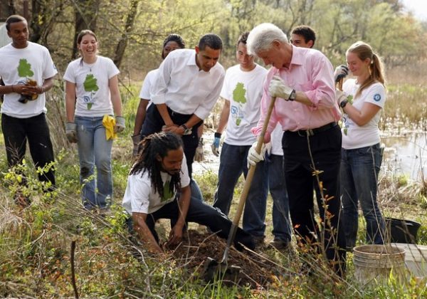 WASHINGTON - APRIL 21:  (AFP OUT)   U.S. President Barack Obama watches as former President Bill Clinton (R) participates in a tree planting event at the Kenilworth Aquatic GardensApril 21, 2009 in Washington, DC. The event was organized by the Student Conservation Association, an Americorp organization.Today Obama signed the Edward M. Kennedy Serve America Act that intends to more than triple the AmeriCorp volunteers to over 250,000 in the United States costing taxpayers roughly a billion dollars a year, over the next five years.  (Photo by Martin H. Simon-Pool/Getty Images)