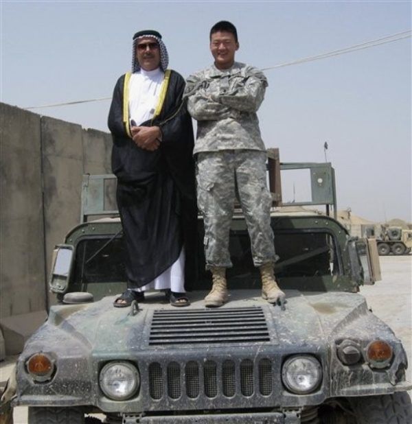 In this 2007 photograph provided by Dan Choi, 1st Lt. Choi, in the Army's 10th Mountain Division, stands atop a Humvee in south Baghdad with an Iraqi sheikh. Choi, a 2003 graduate of the U.S. Military Academy, came out as gay in March 2009 and is a founding member of Knights Out, a newly formed association of gay and lesbian West Point alumni. (AP Photo/Courtesy of Dan Choi) ** NO SALES **