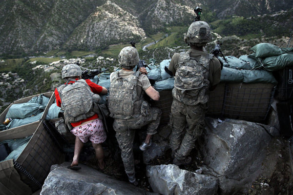Soldiers from the U.S. Army First Battalion, 26th Infantry take defensive positions at firebase Restrepo after receiving fire from Taliban positions in the Korengal Valley of Afghanistan's Kunar Province on Monday May 11, 2009. Spc. Zachery Boyd of Fort Worth, TX, far left was wearing 'I love NY' boxer shorts after rushing from his sleeping quarters to join his fellow platoon members. From far right is Spc. Cecil Montgomery of Many, LA and Jordan Custer of Spokan, WA, center. (AP Photo/David Guttenfelder)