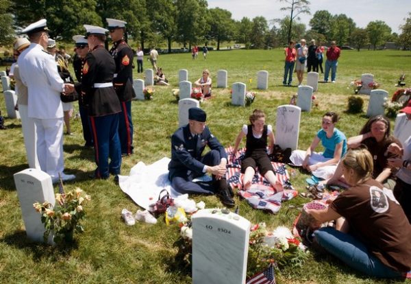 ARLINGTON, VA - MAY 26: Chairman of the Joint Chiefs of Staff Admiral Mike Mullen (L) speaks with U.S. Marines in Section 60 of Arlington National Cemetery May 26, 2008 in Arlington, Virginia. Section 60 is where many of those who have died in the wars in Iraq and Afghanistan have been buried. Memorial Day, a federal holiday in the US, commemorates members of America's military that died while in service to their country. First enacted to honor Union soldiers of the American Civil War, it was expanded after World War I to include casualties of any war or military action. (Photo by Brendan Smialowski/Getty Images)