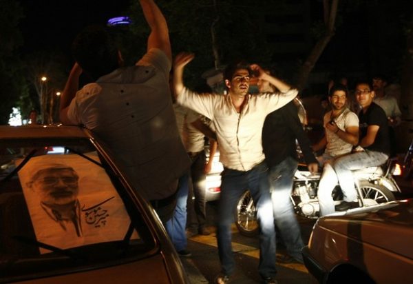 Iranian youth supporters of former prime minister and presidential candidate, Mir Hossein Mousavi, dance in a street in northern Tehran, early June 5, 2009. Several analysts predict a high urban youth turnout in the June 12 presidential election in favour of Mousavi, unknown to many young Iranians but who is passionately promoted by Ahmadinejad's reformist predecessor Mohammad Khatami. AFP PHOTO/BEHROUZ MEHRI (Photo credit should read BEHROUZ MEHRI/AFP/Getty Images)