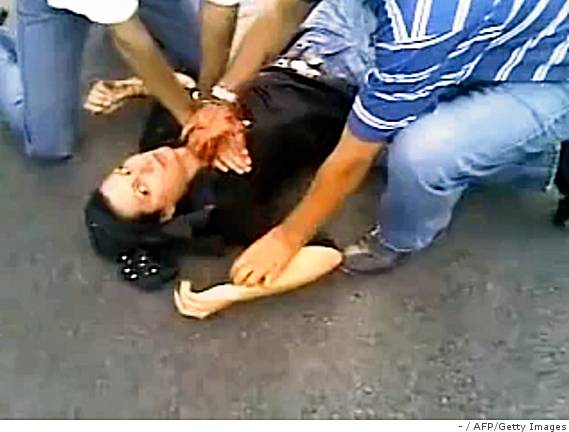 A screen grab taken on June 21, 2009 from a video posted on YouTube allegedly shows Iranian men trying to help a wounded woman named "Neda" after getting shot in the chest during a protest in Tehran on June 20, 2009. At least 10 people were killed in the latest unrest to shake Tehran, state television said on June 21, as the opposition stepped up its defiance of Iran's Islamic rulers over the disputed election