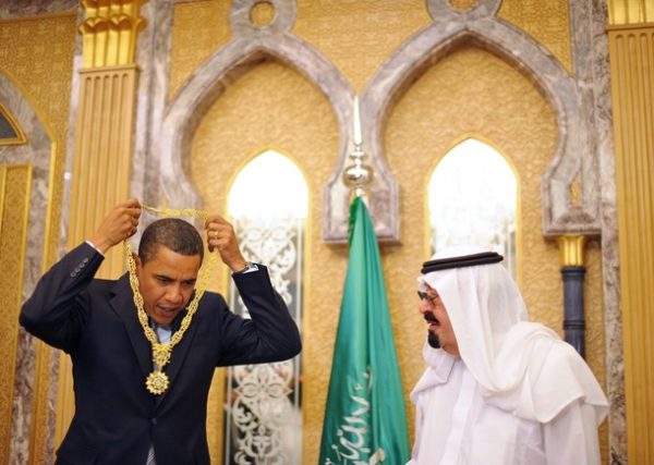 US President Barack Obama (L) takes off the King Abdul Aziz Order of Merit after it was presented to him by Saudi King Abdullah bin Abdul Aziz al-Saud during a bilateral meeting at the king's ranch in al-Janadriya in the outskirts of Riyadh June 3, 2009. Obama launched a landmark Middle East trip to reach out to the world's Muslims, but earned a swift rebuke from Osama bin Laden in a stinging new audiotape. AFP PHOTO/Mandel NGAN (Photo credit should read MANDEL NGAN/AFP/Getty Images)