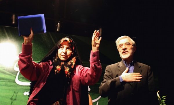 Iranian presidential candidate Mir Hossein Mousavi and his wife Zahra Rahnavard acknowledge supporters during a campaign rally in Tehran on May 30, 2009. The United States on May 29 condemned recent "terrorist attacks" on the soil of its arch-foe Iran, and denied claims by some officials there that it was behind a deadly bombing of a Shiite mosque. AFP PHOTO/ATTA KENARE (Photo credit should read ATTA KENARE/AFP/Getty Images)