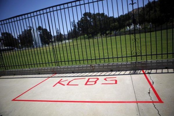 A taped marking for a media outlet is seen outside Forest Lawn cemetery in Los Angeles July 3, 2009. Although details of Tuesday's memorial service have yet to be unveiled, Los Angeles media said Michael Jackson's family may hold a service at the Forest Lawn Mortuary then motorcade to Staples Center. REUTERS/Eric Thayer (UNITED STATES ENTERTAINMENT OBITUARY)