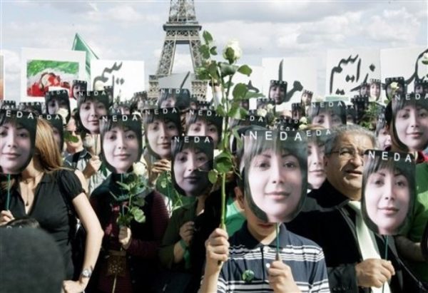 ** CORRECTS SPELLING OF EIFFEL ** People hold placards bearing images of Iranian Neda Agha Soltan, the 27-year-old whose death beamed around the world on the Internet became a rallying cry for opponents of the regime, during a demonstration against Iran's clampdown on opposition activists, at the Trocadero near the Eiffel Tower in Paris, Saturday, July 25, 2009. Protesters across the world on Saturday called on Iran to end its clampdown on opposition activists, demanding the release of hundreds rounded up during demonstrations against the country's disputed election. (AP Photo/Jacques Brinon)