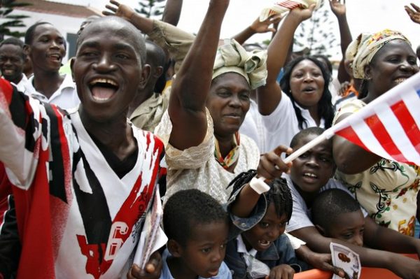 Ghanaians cheer and wave as a convoy carrying U.S. President Barack Obama passes by during his first visit to sub-Saharan Africa, in Ghana's capital Accra, July 11, 2009. U.S. President Barack Obama assured Africa on Saturday that it would not be sidelined from world affairs and hailed democratic Ghana as a model for other African countries. REUTERS/Finbarr O'Reilly (GHANA POLITICS)