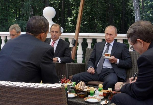 US President Barack Obama (2L) and Russian Prime Minister Vladimir Putin (2R) converse while having traditional Russian tea and snacks on a terrace at Putin's residence outside Moscow in Novo-Ogarevo on July 7, 2009. Obama praised Vladimir Putin's "extraordinary work" as Russia's president and now prime minister, but admitted their two nations still do not agree on everything. AFP PHOTO / RIA NOVOSTI / POOL / ALEXEY DRUZHININ (Photo credit should read ALEXEY DRUZHININ/AFP/Getty Images)