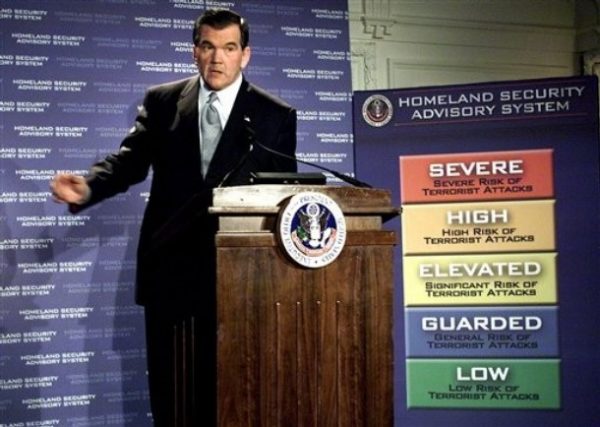 FILE - In this March 12, 2002 file photo, Homeland Security Director Tom Ridge unveils a color-coded terrorism warning system in Washington. The Obama administration will announce Tuesday, July 14, 2009,  that it will review the nation's multicolored terror alert system that was created after the Sept. 11, 2001, attacks.  (AP Photo/Joe Marquette)