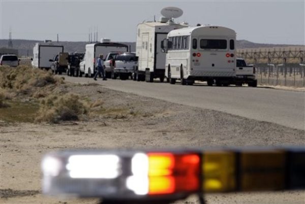 An emergency operations team prepares to move into an area where an Air Force F-22 fighter jet, on a test fight from nearby Edwards Air Force Base, crashed in the Mojave Desert about 25 miles west of Barstow, Calif., Wednesday, March 25, 2009. (AP Photo/Reed Saxon)