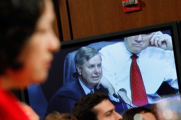 WASHINGTON - JULY 14: Sen. Senator Lindsey Graham (R-SC)(C) is flanked by Sen. Jon Kyl (R-AZ) (R) is seen on a monitor as he questions Judge Sonia Sotomayor during the second day of her confirmation hearings July 14, 2009 in Washington, DC. Sotomayor faces a full day of questioning from Senators on the committee today.  (Photo by Mark Wilson/Getty Images)