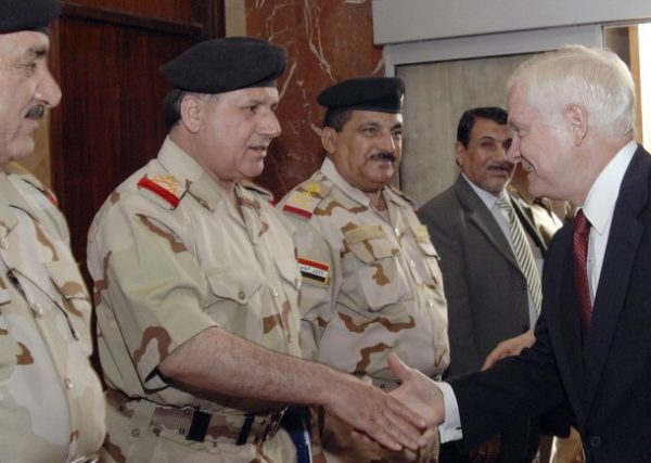 U.S. Secretary of Defense Robert Gates (R) shakes hands with Iraqi commanders during his visit to Baghdad July 28, 2009. Gates said during a visit to Iraq on Tuesday that the withdrawal of U.S. combat troops from urban bases was paying off as Iraqi forces assumed the lead for Iraq's fragile security. REUTERS/Stringer (IRAQ CONFLICT POLITICS MILITARY)