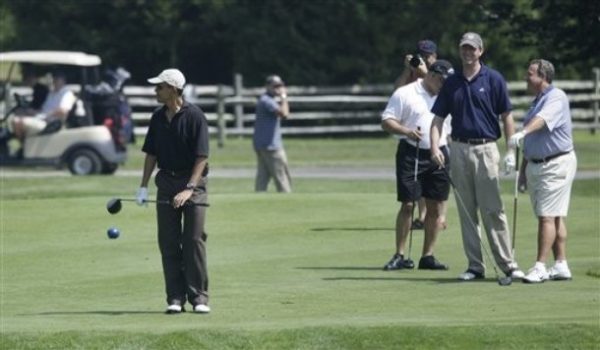 President Barack Obama pauses with his driver after hitting his first shot off the tee as he plays golf during his vacation on Martha's Vineyard in Oak Bluffs, Mass., Monday, Aug. 24, 2009. (AP Photo/Alex Brandon)