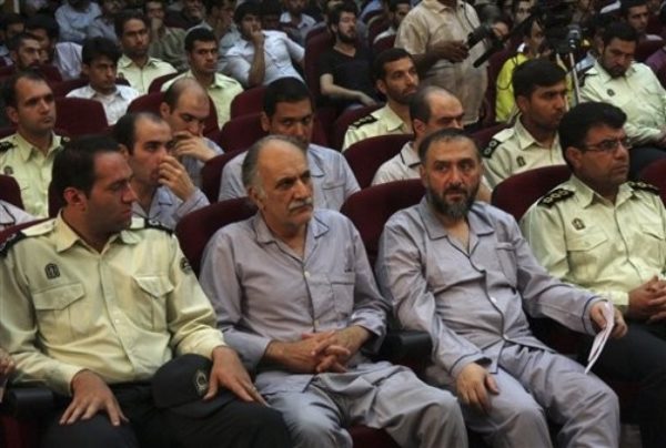 ** ADDS ID OF PERSON SECOND FROM RIGHT ** In this photo released by the semi-official Iranian Fars News Agency, former vice president Mohammad Ali Abtahi, second from right, is seen with other defendants sit at a court room in Tehran, Iran, Saturday, Aug. 1, 2009. Opposition political activists and protesters stood trial in Tehran Saturday on charges of rioting and conspiring against the ruling system in the country's first trial following the disputed presidential election, Iran's state media reported. (AP Photo/Fars News Agency, Hossein Salehi Ara) EDITORS NOTE AS A RESULT OF AN OFFICIAL IRANIAN GOVERNMENT BAN ON FOREIGN MEDIA COVERING SOME EVENTS IN IRAN, THE AP WAS PREVENTED FROM INDEPENDENT ACCESS TO THIS EVENT