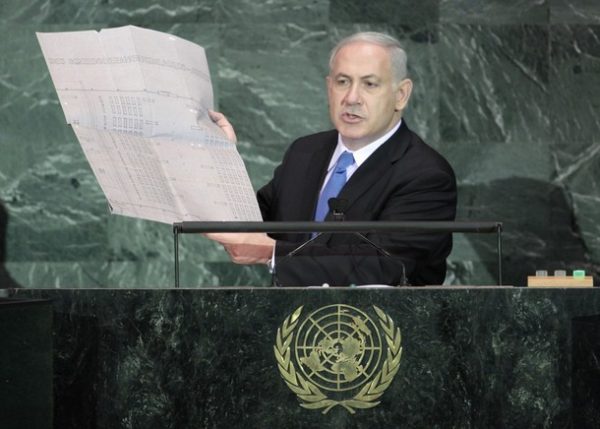 Israeli Prime Minister Benjamin Netanyahu holds up a document outlining plans for the Auschwitz death camp as he addresses the 64th United Nations General Assembly at U.N. headquarters in New York, September 24, 2009. REUTERS/Ray Stubblebine (UNITED STATES POLITICS)
