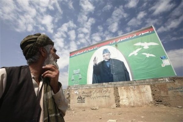 An Afghan elderly man looks at an election billboard of Afghan President Hamid Karzai, who is a presidential candidate in Kabul, Afghanistan, on Monday, Aug. 31, 2009. Major fraud complaints in the Afghan presidential election have surged to nearly 700, raising concern that the volume of cases that must be investigated will delay announcement of a winner and formation of a new government. (AP Photo/Musadeq Sadeq)