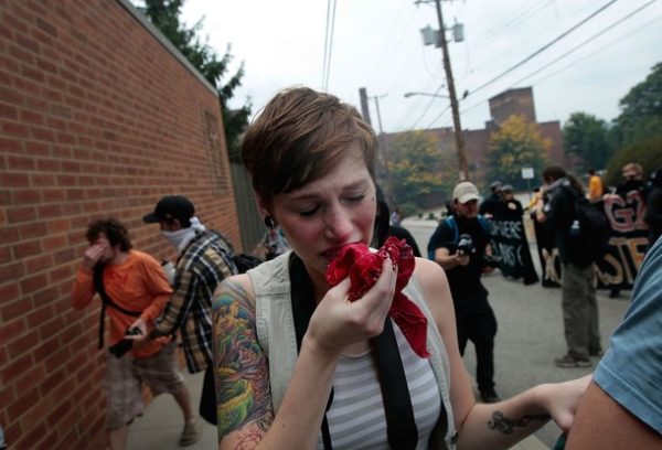 PITTSBURGH - SEPTEMBER 24: A protestor cries from tear gas fired on marchers by riot police during an unpermitted march against the G-20 Summit on September 24, 2009 in Pittsburgh, Pennsylvania. Marchers gathered in neighborhoods several miles from Pittsburgh's downtown but were dispersed by police bearing tear gas and amplification machines. Dignitaries begin arriving for the G-20 Summit today while authorities vow to prevent expected protests from disrupting the meeting. (Photo by Chris Hondros/Getty Images)