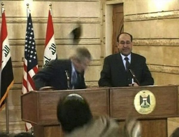 In this image from APTN video, an man throws a shoe at President George W. Bush during a news conference with Iraq Prime Minister Nouri al-Maliki on Sunday, Dec. 14, 2008, in Baghdad. The man threw two shoes at Bush, one after another. Bush ducked both throws, and neither man was hit. (AP Photo/APTN)