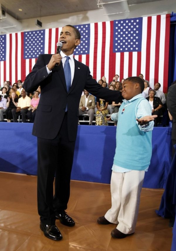 U.S. President Barack Obama receives a question from Tyren Scott, 9, of Paulina Louisina, during a town hall style meeting at the University of New Orleans October 15, 2009.    REUTERS/Kevin Lamarque  (UNITED STATES POLITICS)