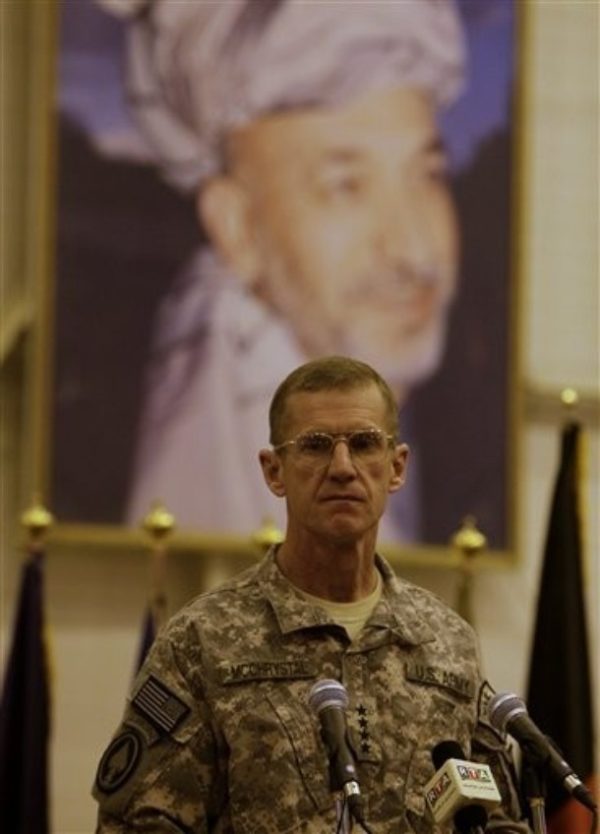 Gen. Stanley McChrystal, the top U.S. and NATO commander for Afghanistan, talks in front of a giant poster of Afghan President Hamid Karzai during a ceremony with the Afghan Air Force in Kabul, Afghanistan, Sunday, Nov. 15, 2009. Two new C-27 transport planes were donated by Italy and the United States to the Afghan Air Force. (AP Photo/Anja Niedringhaus)