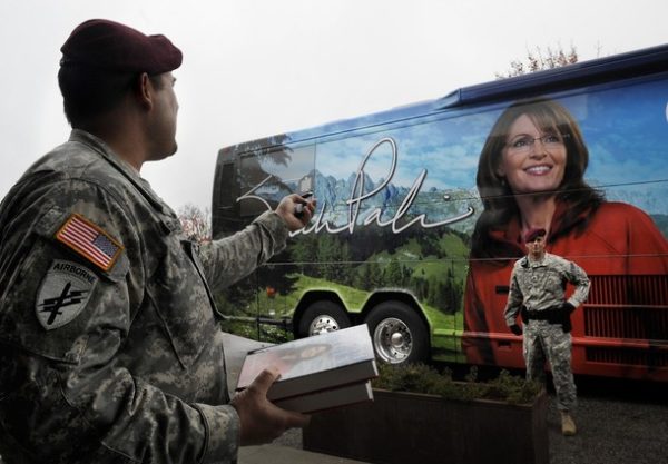 FORT BRAGG, NC - NOVEMBER 23: 82nd Airborne Sgt. David Vogelsang, War Transition Unit, takes a picture of a military police officer in front of former Alaska Gov. Sarah Palin's tour bus at the signing of her memoir "Going Rogue" at the North Post Exchange on November 23, 2009 in Fort Bragg, North Carolina. Hundreds of people turned out for Palin's appearance. (Photo by Sara D. Davis/Getty Images)