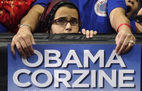 A girl listens to U.S. President Barack Obama speak at a campaign rally for New Jersey Governor Jon Corzine at the Prudential Center in Newark, November 1, 2009.    REUTERS/Jim Young  (UNITED STATES POLITICS)